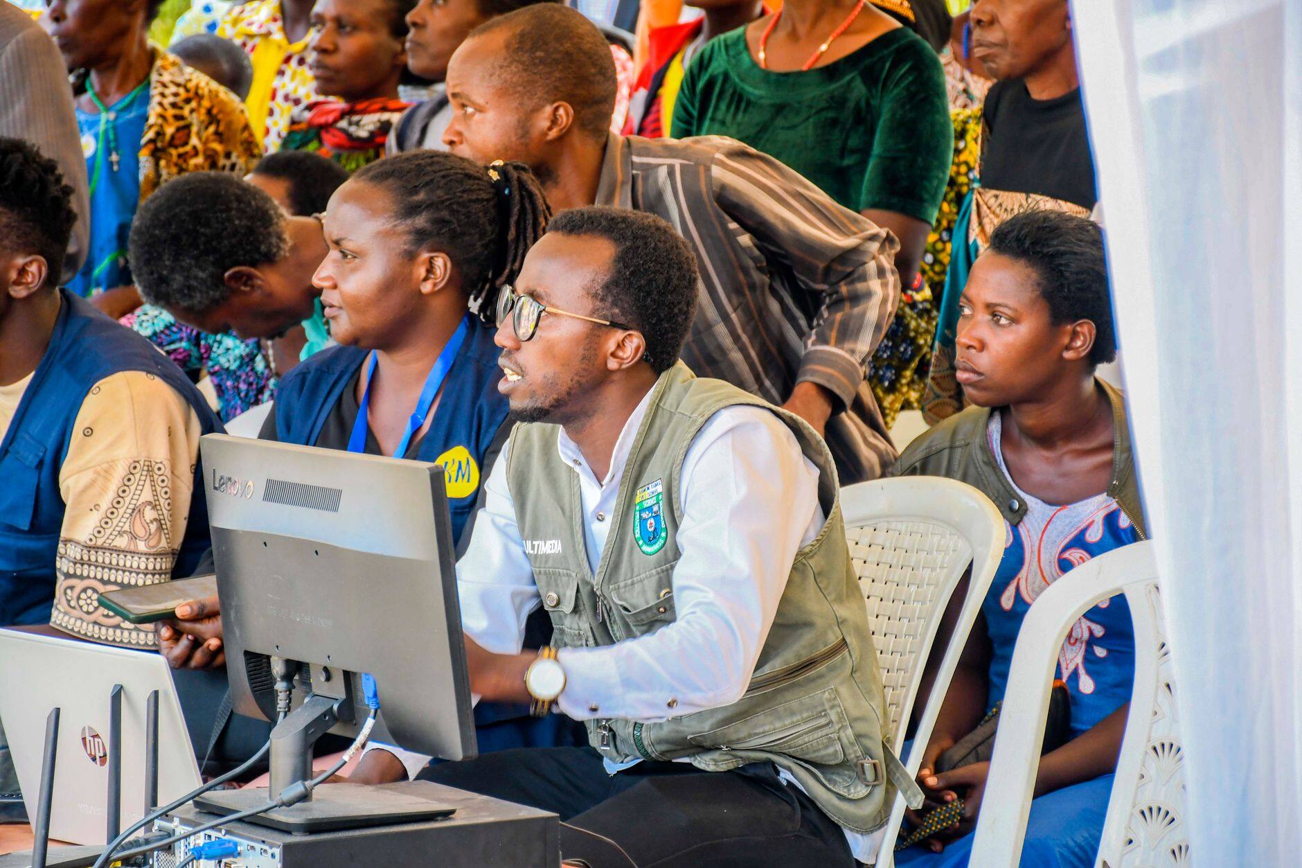 People working at computers in a busy tech space