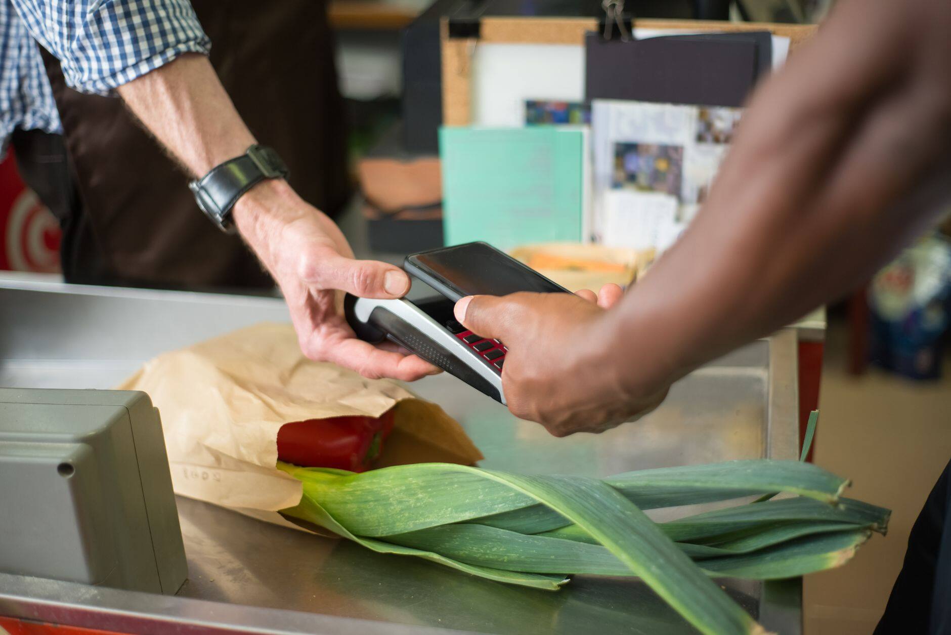 A customer paying contactlessly at a checkout