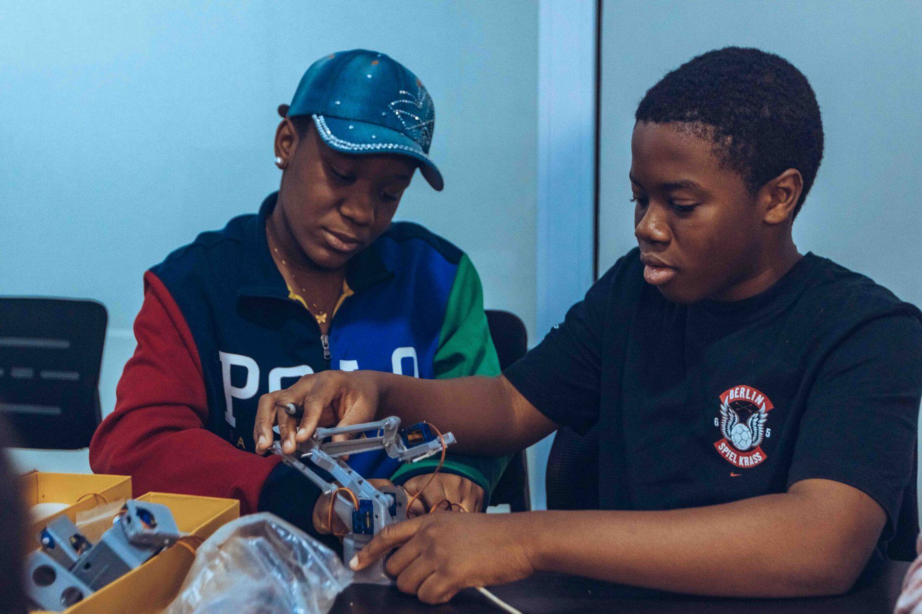 Two students assembling a robot